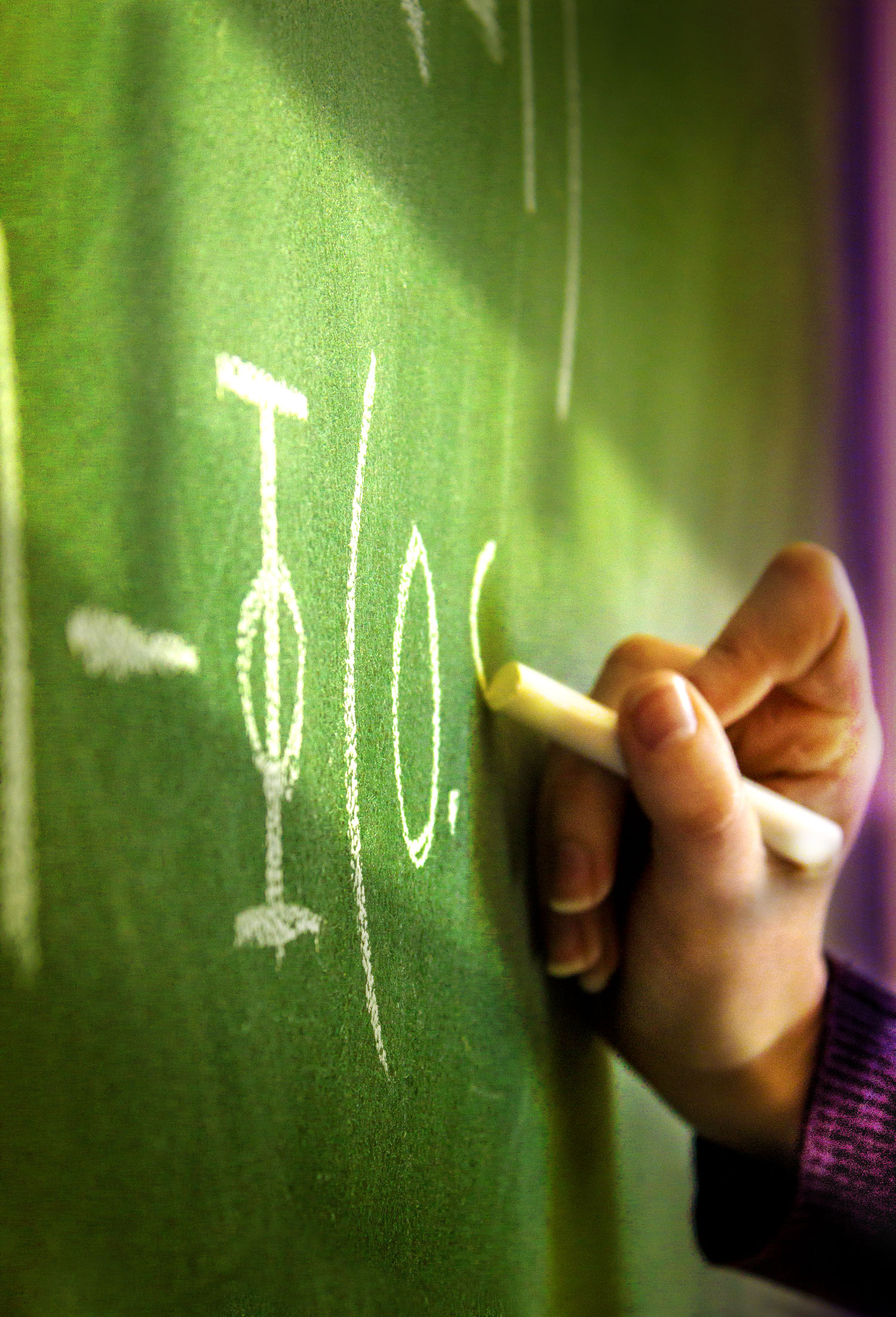 Photo of hand writing on a board